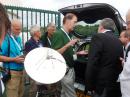 Hans van Alphen, PA0EHG, demonstrates a small-dish EME 10 GHz beacon receiver. [Rick Rosen, K1DS, photo]